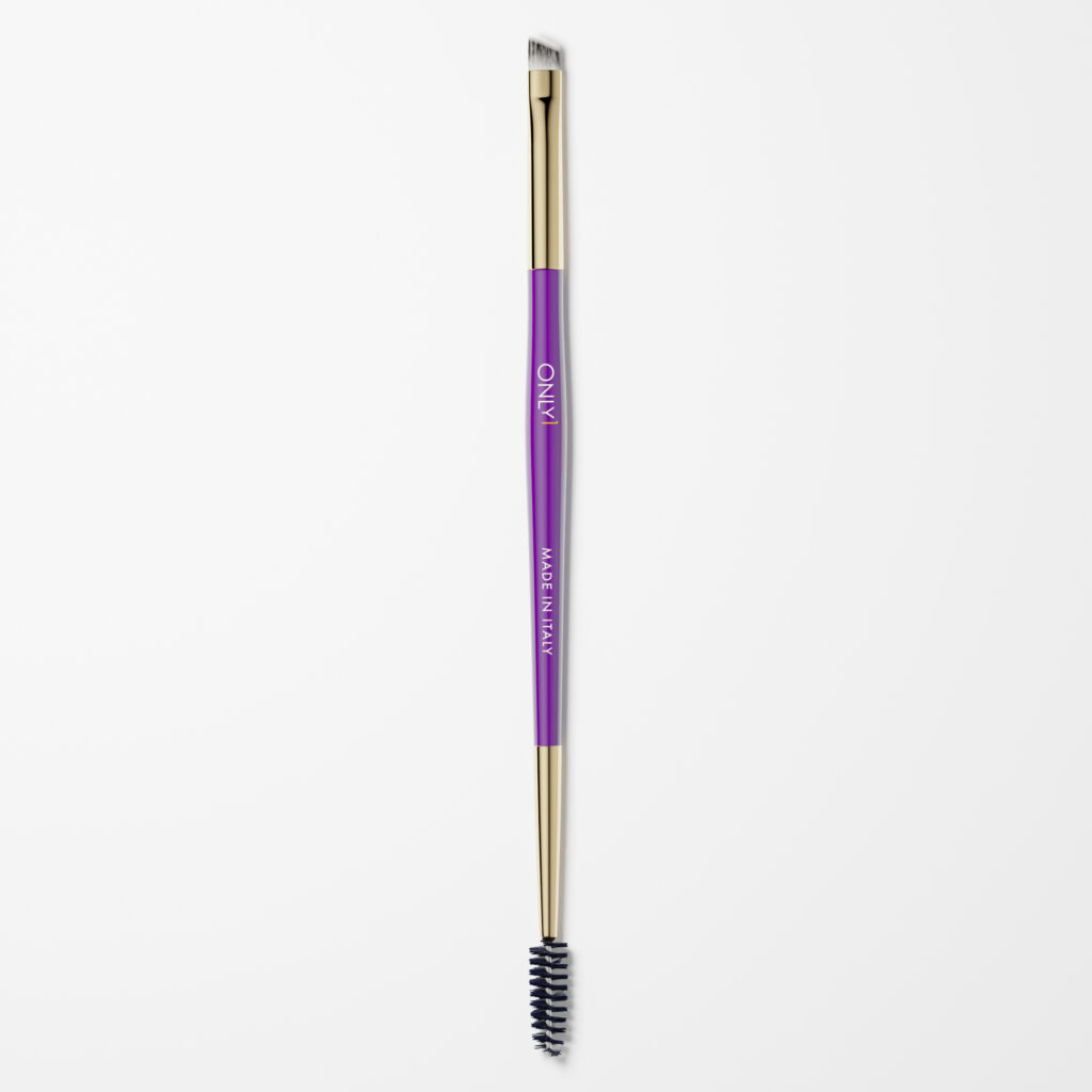 Double-ended eyebrow brush with a purple handle and gold accents, featuring an angled brush on one end and a spoolie on the other, on a plain white background.