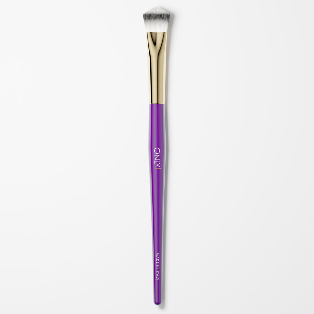 Small concealing brush with a purple handle, gold accents, and white bristles on a plain white background.