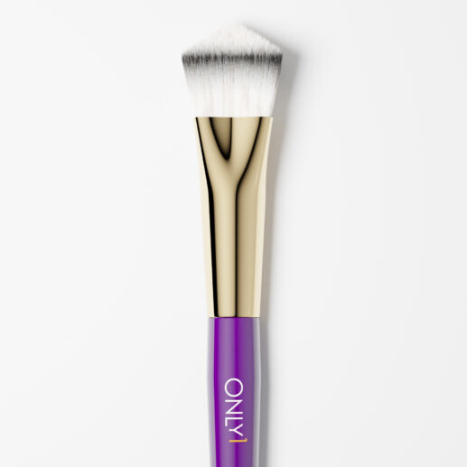 Small foundation brush with a purple handle, gold accents, and dense white bristles on a plain white background.